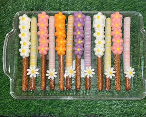 Decorative chocolate-dipped pretzel rods for graduations and sports parties